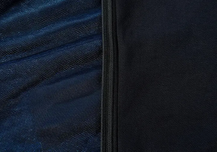 Close-up comparison showing the distinct textures of breathable wader fabric versus neoprene material.