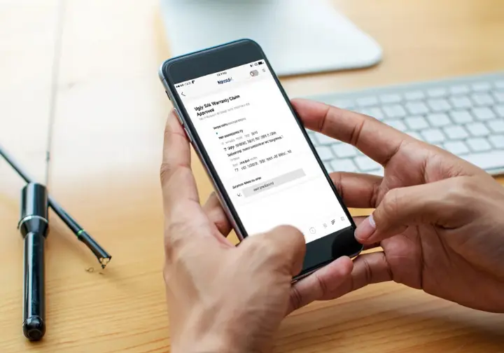 Smartphone screen displaying an email confirming an approved Ugly Stik GX2 warranty claim, representing user support experience.