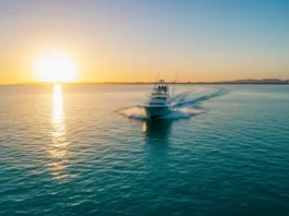 Sport fishing boat speeding across calm water at sunset in La Paz, Mexico, representing fishing charter adventures.