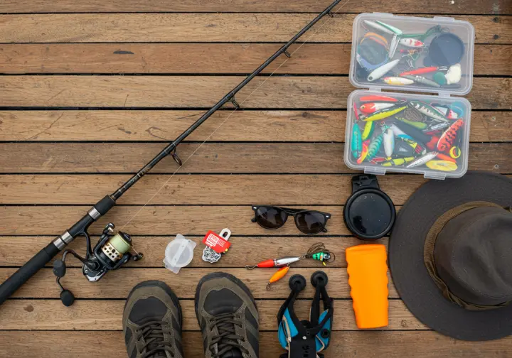 Essential fishing gear laid out, ready for a charter fishing trip.