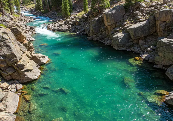 Blue River hidden rhythms: turquoise headwaters above Green Mountain Reservoir with angler in distance.