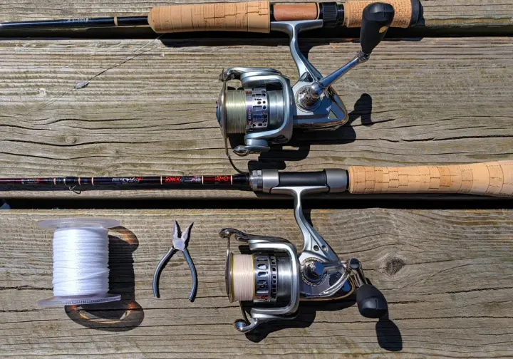 Essential saltwater angler's toolkit including rod, reel, line, terminal tackle, and tools laid out on a dock.