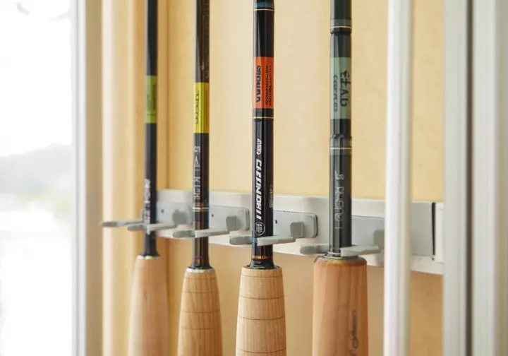 Display of three top recommended saltwater fishing rods (inshore, boat, surf) in a rod rack.