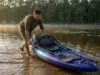 Best Fishing Kayaks Under $1000 Worth Rigging Up Angler pushing a Vibe Sea Ghost 110 fishing kayak off a shallow bank at first light