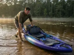 Best Fishing Kayaks Under $1000 Worth Rigging Up Angler pushing a Vibe Sea Ghost 110 fishing kayak off a shallow bank at first light