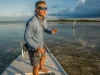 Best Polarized Sunglasses for Fishing Glass vs Poly Angler in polarized fishing sunglasses scanning a Florida Keys flat for tailing fish at first light