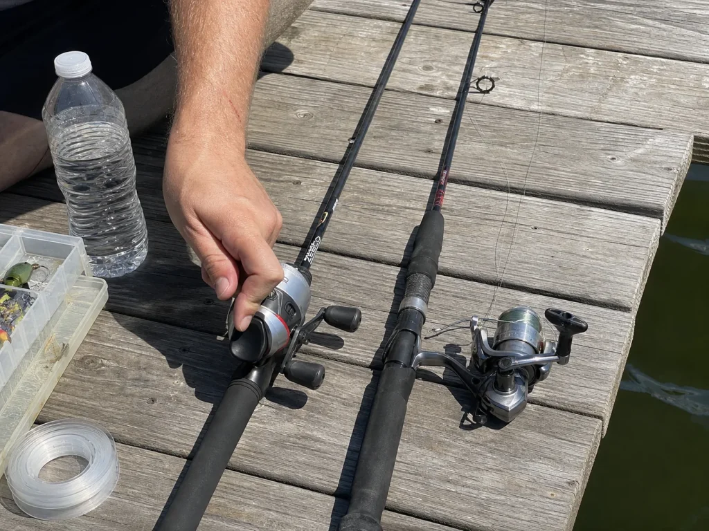 Spincast combo and open-face spinning reel side by side on a dock, comparing beginner reel types