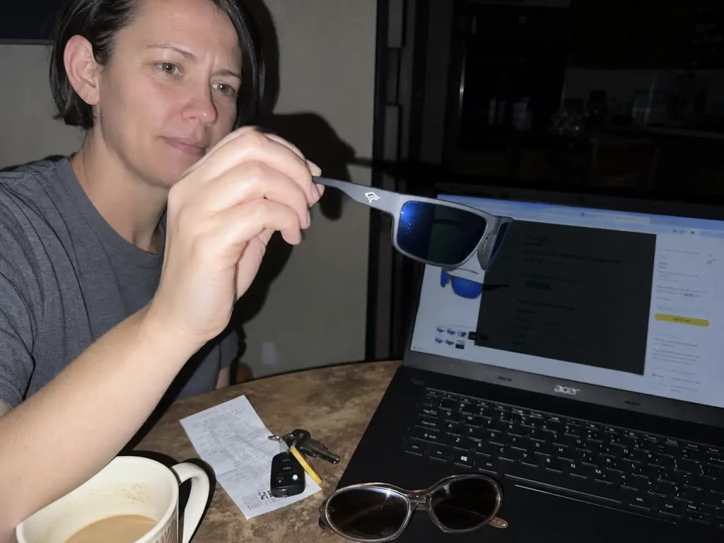 Polarized sunglasses held in front of a laptop screen going black during the polarization test