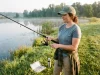 What Gear Do You Need to Start Fishing? Less Than You Think Beginner holding a spinning combo at a quiet pond, the basic gear you need to start fishing