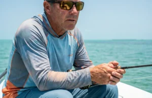 Best Polarized Sunglasses for Fishing: 2026 Clarity Guide Close-up of a saltwater angler wearing polarized sunglasses scanning the water flats for fish.