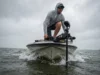 Best Trolling Motor Guide: Matching Boat & Electronics Angler on the bow of a bass boat using a trolling motor to fight heavy wind and waves.