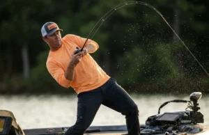 How to Set the Hook: Physics, Timing, & Technique Angler setting the hook aggressively on a bass boat during sunrise, rod bent double with water spraying from the line.
