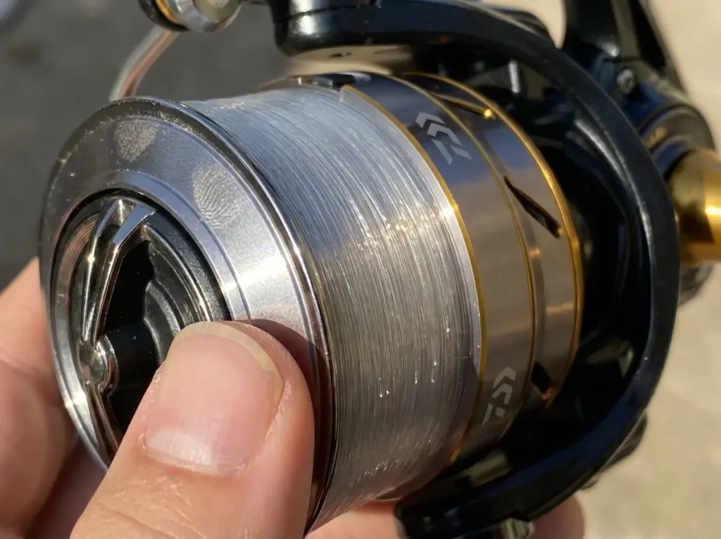 Close-up of a spinning reel spool filled to about an eighth inch from the lip