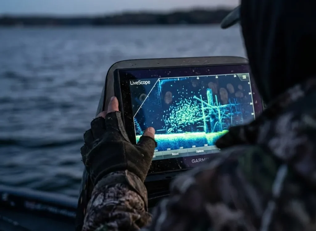 Close up of a fish finder screen displaying side imaging sonar data of a crappie school near underwater brush.