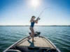Lead-Free Tackle: A Data-Backed Performance Guide A full-body shot of a young woman in a swimsuit casting a fishing rod from the deck of a boat on a sunny day.