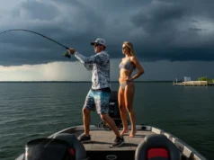 Fishing Barometric Pressure: A Data-Backed Angler’s Guide A fit couple fishing on a boat under a dramatic, pre-storm sky, representing the effect of barometric pressure on fishing.