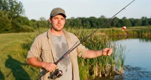 Where Budget Fishing Gear Wins and Where It Fails Angler holding a budget fishing gear combo on a pond bank in late afternoon light