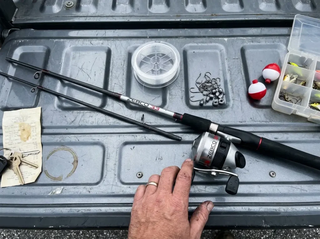 Budget fishing gear laid out on a truck tailgate showing where to spend and save