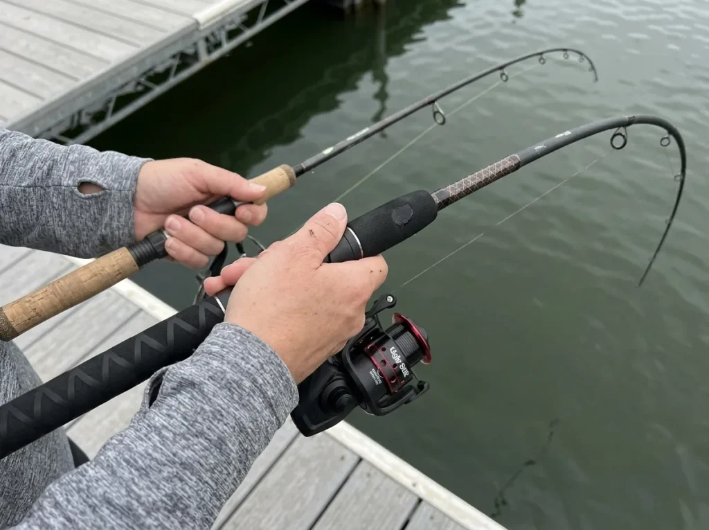 Two spinning rods held side by side showing different bend points to compare rod power and action