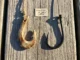 From Bone to Carbon: The Complete History of Fishing A side-by-side comparison of a prehistoric bone fish hook and a modern carbon steel hook on weathered wood.