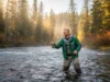 Pacific Northwest Salmon Run: The Definitive Field Guide A man in his 30s fly fishing in a beautiful Pacific Northwest river during the autumn salmon run.