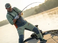 Rod Action vs Power: The Lure Pairing Guide Angler setting the hook hard on a bass boat, rod bent deeply showing power and action.