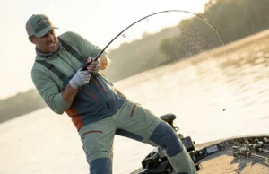 Rod Action vs Power: The Lure Pairing Guide Angler setting the hook hard on a bass boat, rod bent deeply showing power and action.