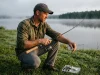 Why Rod Power and Action Aren’t the Same Thing Angler flexing a St. Croix Triumph rod to feel its power and action on a lake shore at dawn