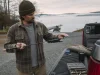 Does Your Fishing Rod Spine Even Matter? Sort Of Angler at a truck tailgate rolling a fishing rod tip to find the blank spine at dawn