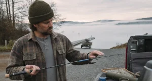 Does Your Fishing Rod Spine Even Matter? Sort Of Angler at a truck tailgate rolling a fishing rod tip to find the blank spine at dawn