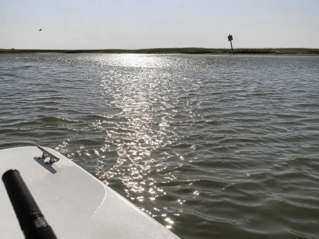Flat silver glare across open water hiding everything below the surface