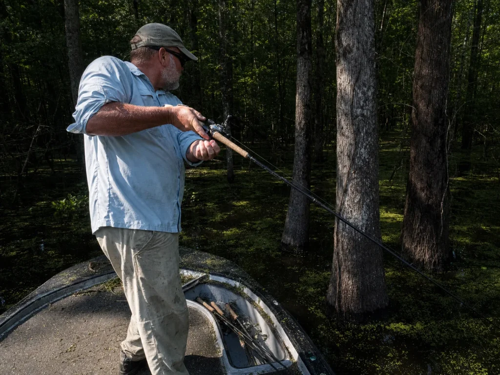 Angler flipping a jig into heavy cover, the repetitive technique that loads the forearm and elbow