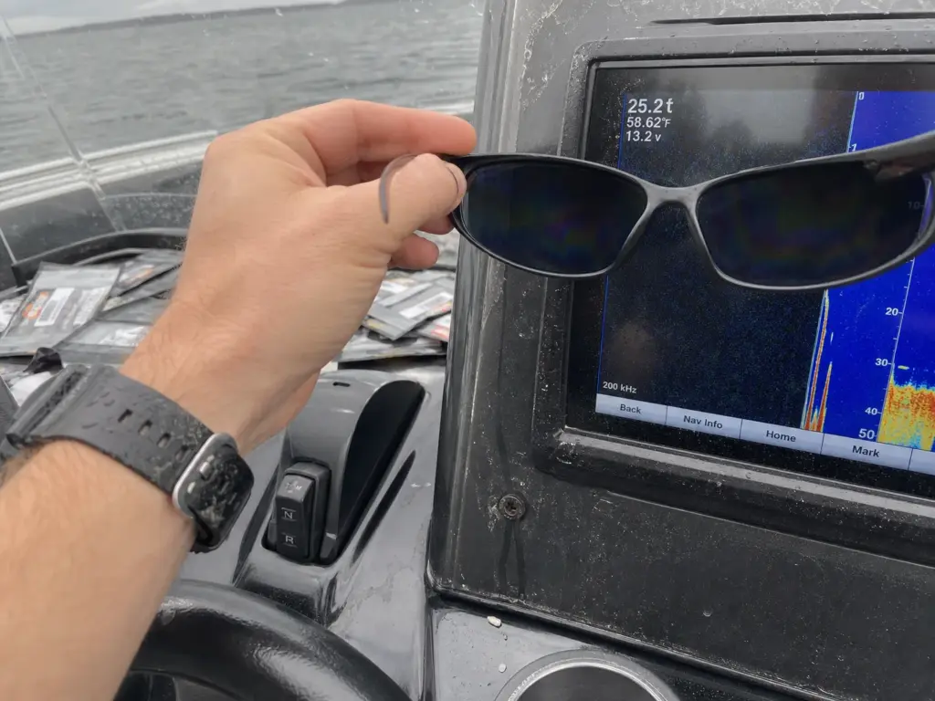 Fish finder screen going dark through polarized sunglasses at the boat console