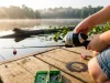 Best Kids Fishing Poles That Actually Stay Tangle-Free Young girl on a dock holding a tangle-free kids fishing pole with a push-button spincast reel