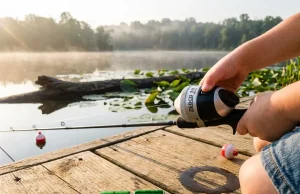 Best Kids Fishing Poles That Actually Stay Tangle-Free Young girl on a dock holding a tangle-free kids fishing pole with a push-button spincast reel