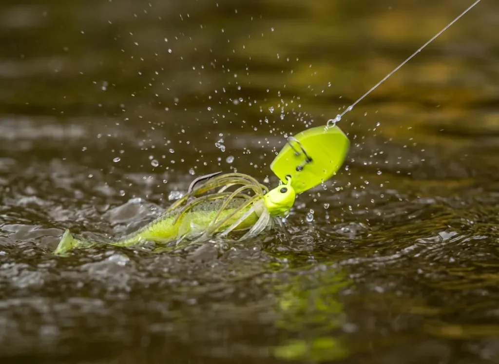 A bright chartreuse fishing lure splashing into murky, brown water, creating a disturbance to trigger fish strikes.