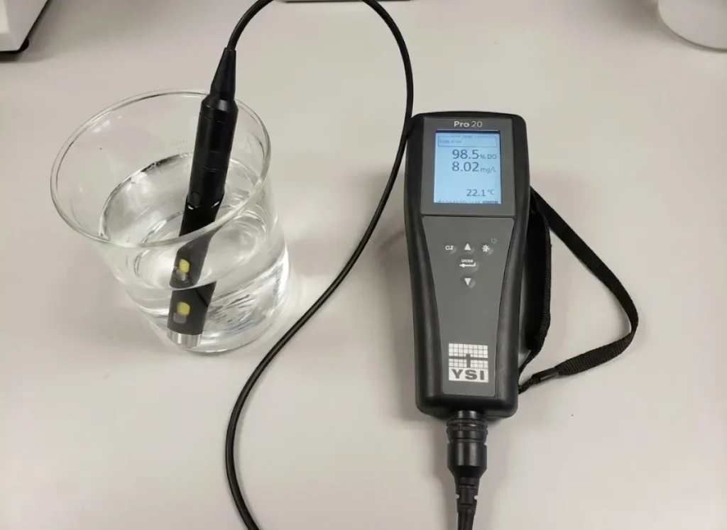 Close-up macro shot of a scientific optical dissolved oxygen probe breaking the water surface tension.