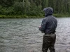 Why Waterproof Breathable Fabrics Still Leave You Wet Angler standing in a river in breathable waders and a wading jacket during light rain