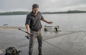 3 Rod and Reel Balance Mistakes That Cost You Casts Angler resting a spinning combo on one finger to balance rod and reel at a lake ramp