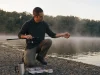 Why Longer Rod Length Rarely Wins on Your Water Angler rigging a 7-foot rod at first light, matching rod length to the fishing situation on a quiet reservoir bank