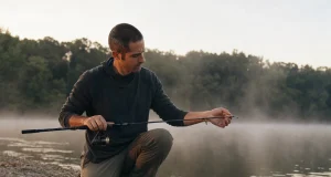 Why Longer Rod Length Rarely Wins on Your Water Angler rigging a 7-foot rod at first light, matching rod length to the fishing situation on a quiet reservoir bank
