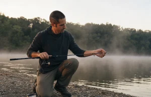 Why Longer Rod Length Rarely Wins on Your Water Angler rigging a 7-foot rod at first light, matching rod length to the fishing situation on a quiet reservoir bank