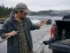 5 Mistakes That Void Your Fishing Rod Warranty Angler inspecting a fishing rod at dawn for warranty-voiding damage before a trip