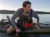 5 Kayak Reentry Mistakes That Keep You in the Water Angler in a kayak fishing PFD beside his sit-on-top after a deep water kayak reentry drill