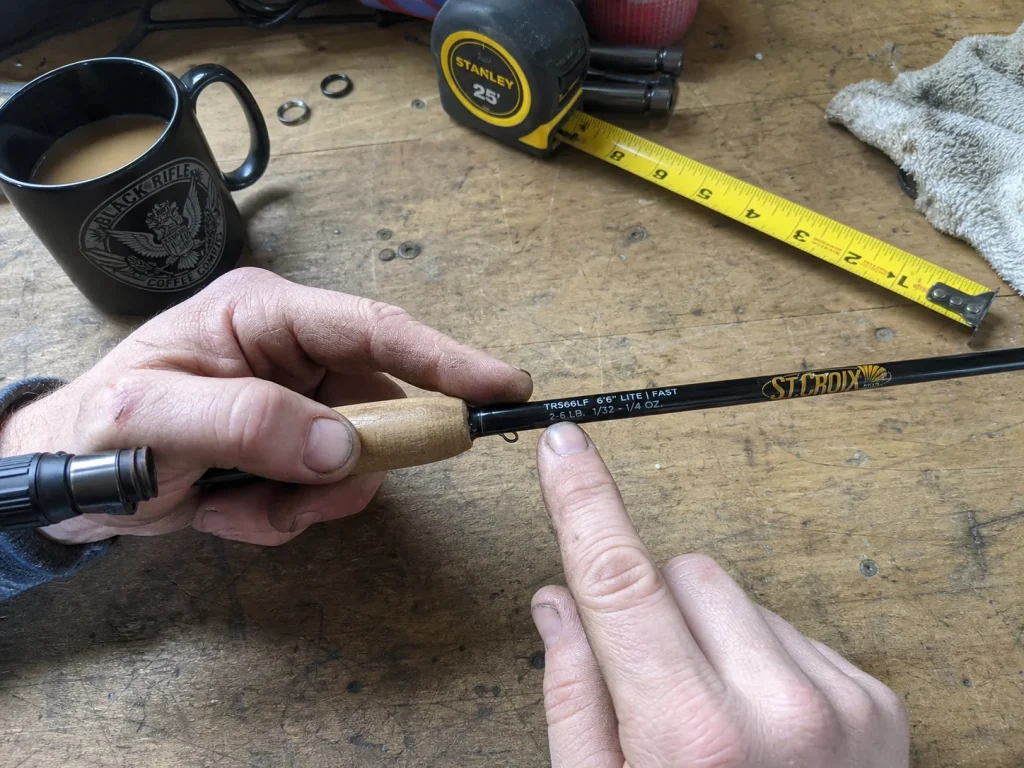 Close-up of a St. Croix Triumph rod blank showing the printed TRS66LF model code above the reel seat