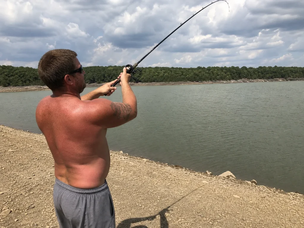 Angler mid-cast with a loaded 7-foot rod showing how rod length widens the casting arc