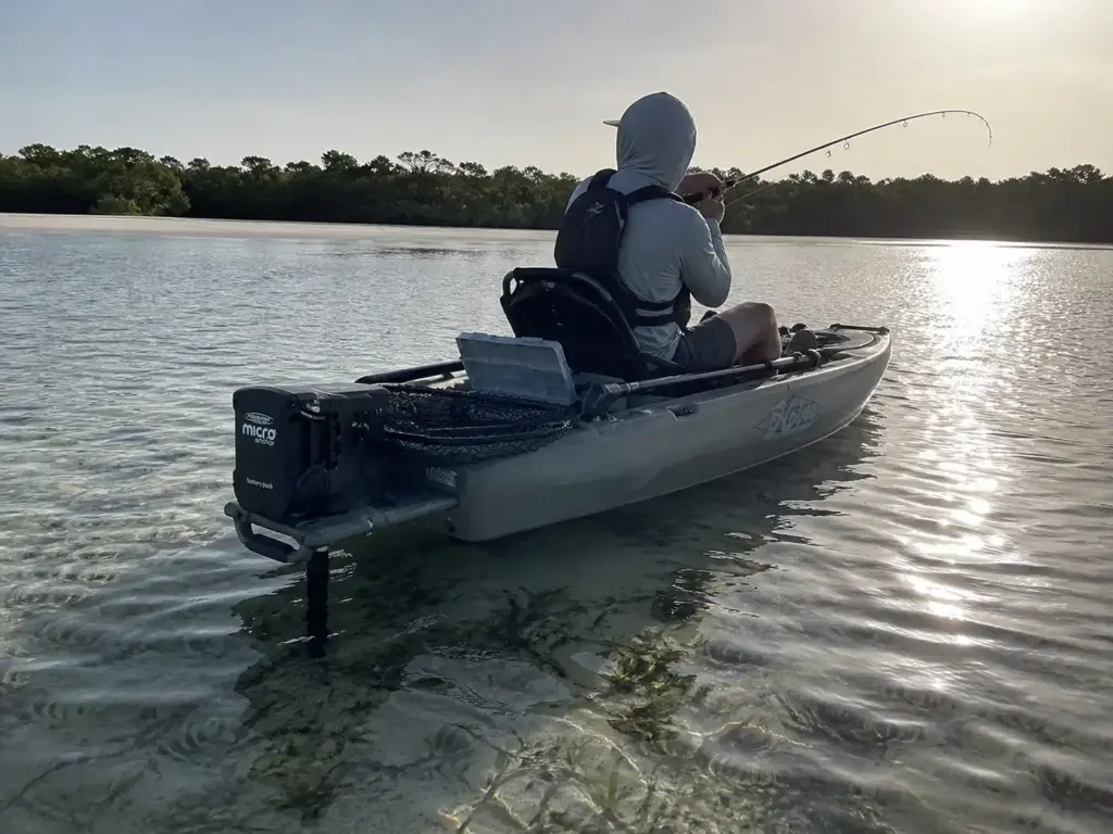 Kayak angler on a shallow tidal flat with a Power-Pole Micro anchor deployed