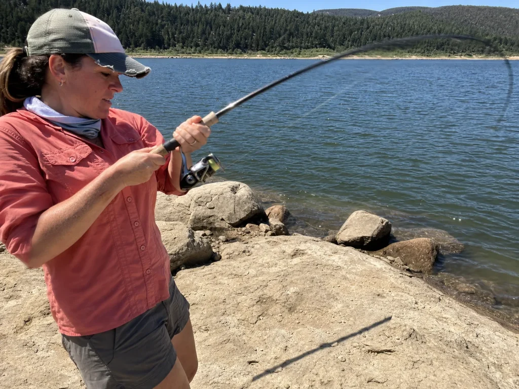 A bent fishing rod loaded under the weight of a hooked fish showing how rod power resists the load