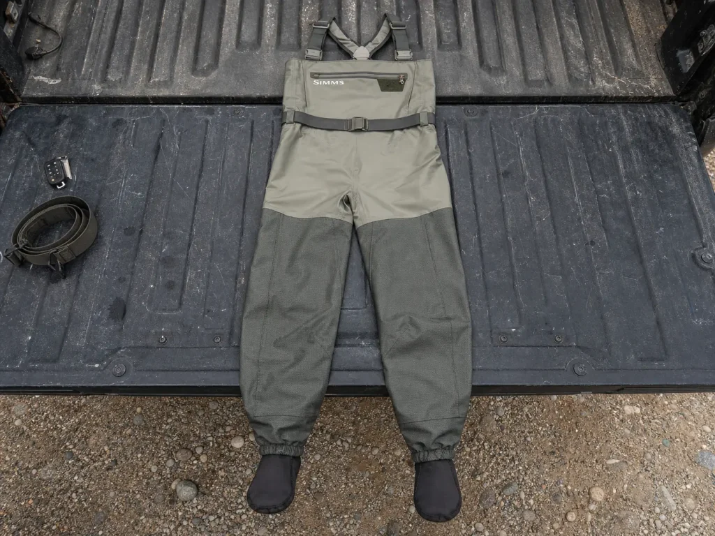 Breathable stockingfoot waders laid out showing a lighter upper and a reinforced lower body