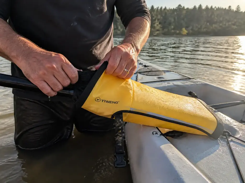 Inflatable paddle float sleeved onto a paddle blade and braced under a kayak deck line as an outrigger